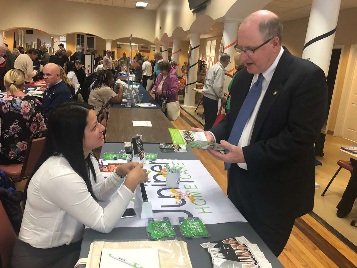 State Sen. Kevin Kelly talks with Sheila Perez of Juniper Home Care during the senior health and wellness fair Oct. 28, 2019, at the Shelton Senior Center.
