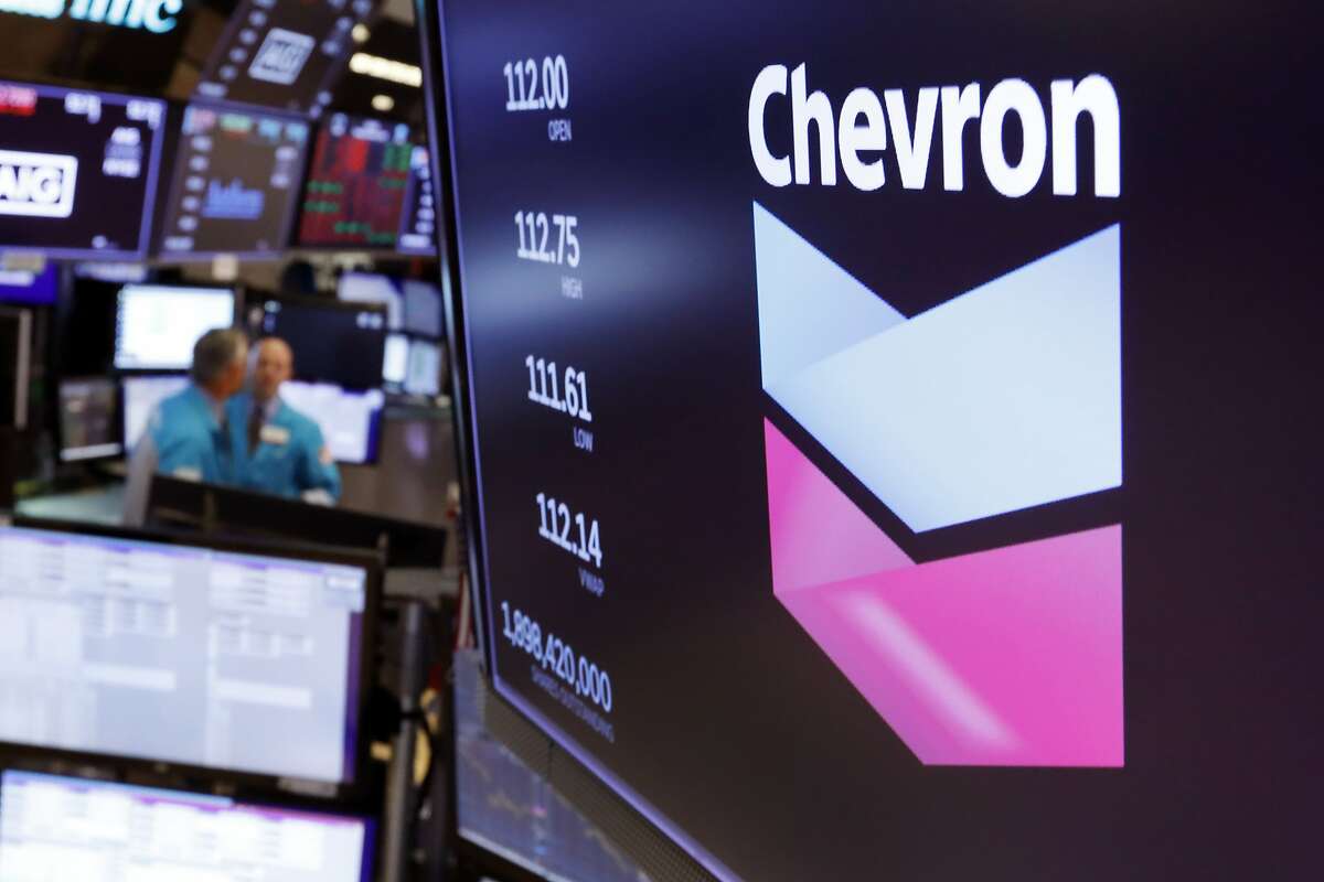 FILE - This Oct. 8, 2019, file photo the logo for Chevron appears above a trading post on the floor of the New York Stock Exchange. Chevron Corp. reports financial results Friday, Nov. 1. (AP Photo/Richard Drew, File)