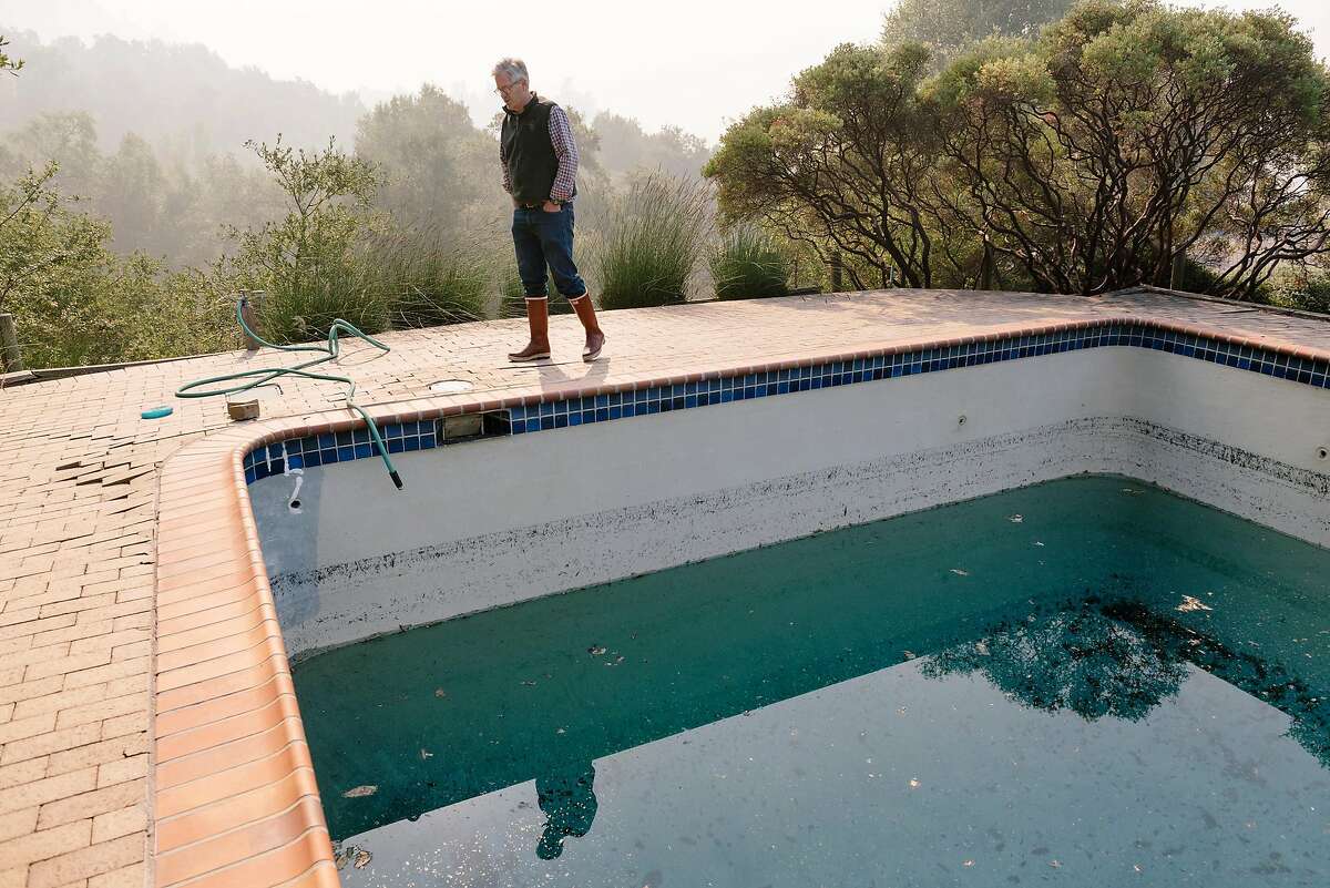 Parke Hafner, owner and winemaker of Hafner Vienyards, looks over a swimming pool on his property that was used by firefighters to fight of the recent encroachment of Kincade Fire, in Healdsburg, California, on Tuesday, Oct. 29, 2019.