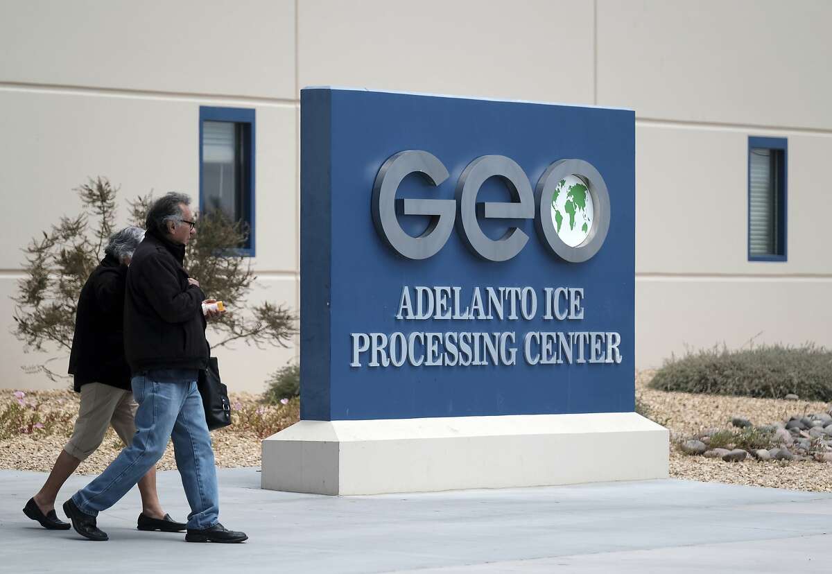 This April 20, 2019 file photo shows the U.S. Immigration and Enforcement Processing Center operated by GEO Group, Inc. (GEO) a Florida-based company specializing in privatized corrections in Adelanto, Calif. California is banning the use of for-profit, private detention facilities, including those the federal government uses for immigrants awaiting deportation hearings. California Gov. Gavin Newsom announced Friday, Oct. 11, 2019 he had signed a measure into law that helps fulfill his promise to end the use of private prisons. (AP Photo/Richard Vogel, File)