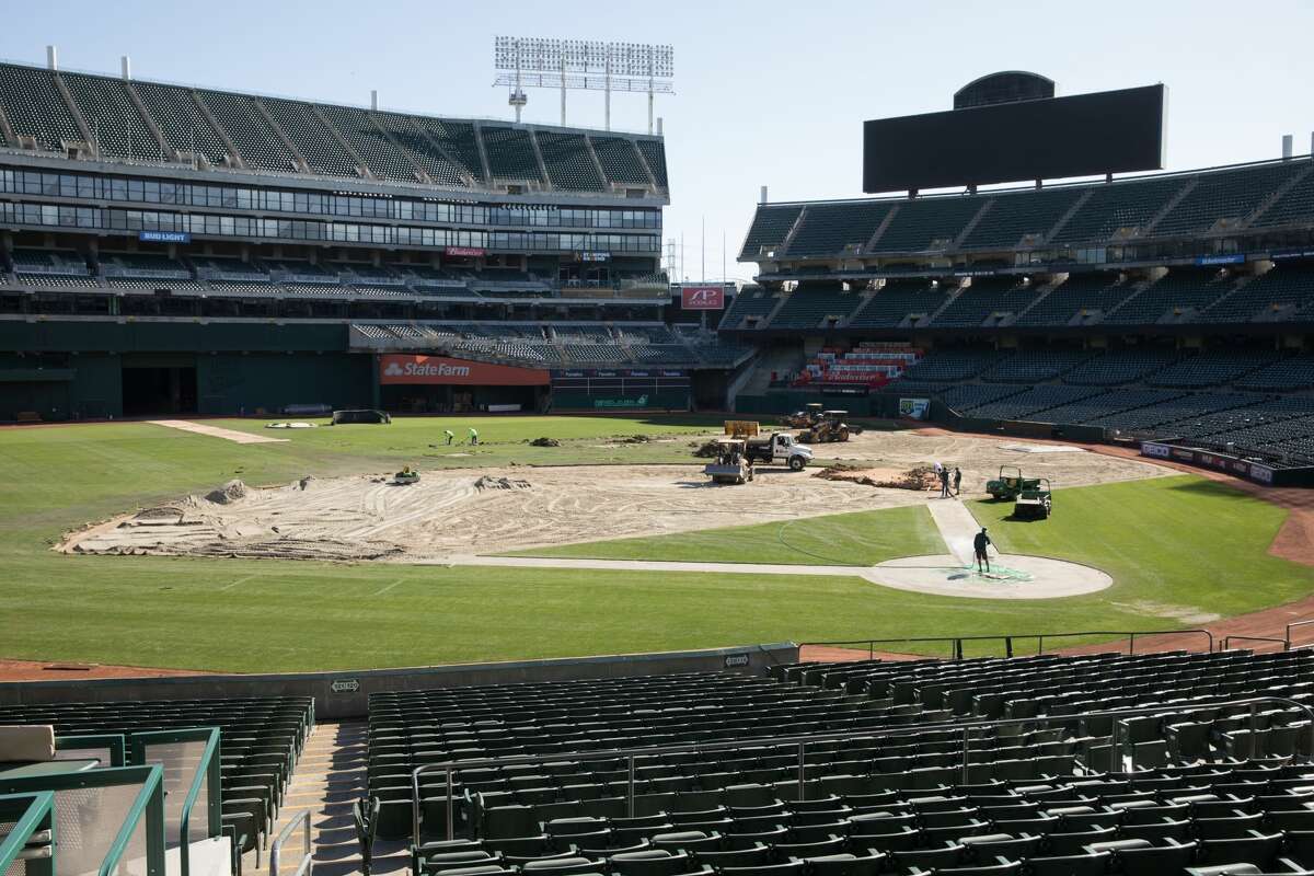 Groundskeepers for the Oakland A's convert the field of the Oakland Coliseum from a baseball to a football field.