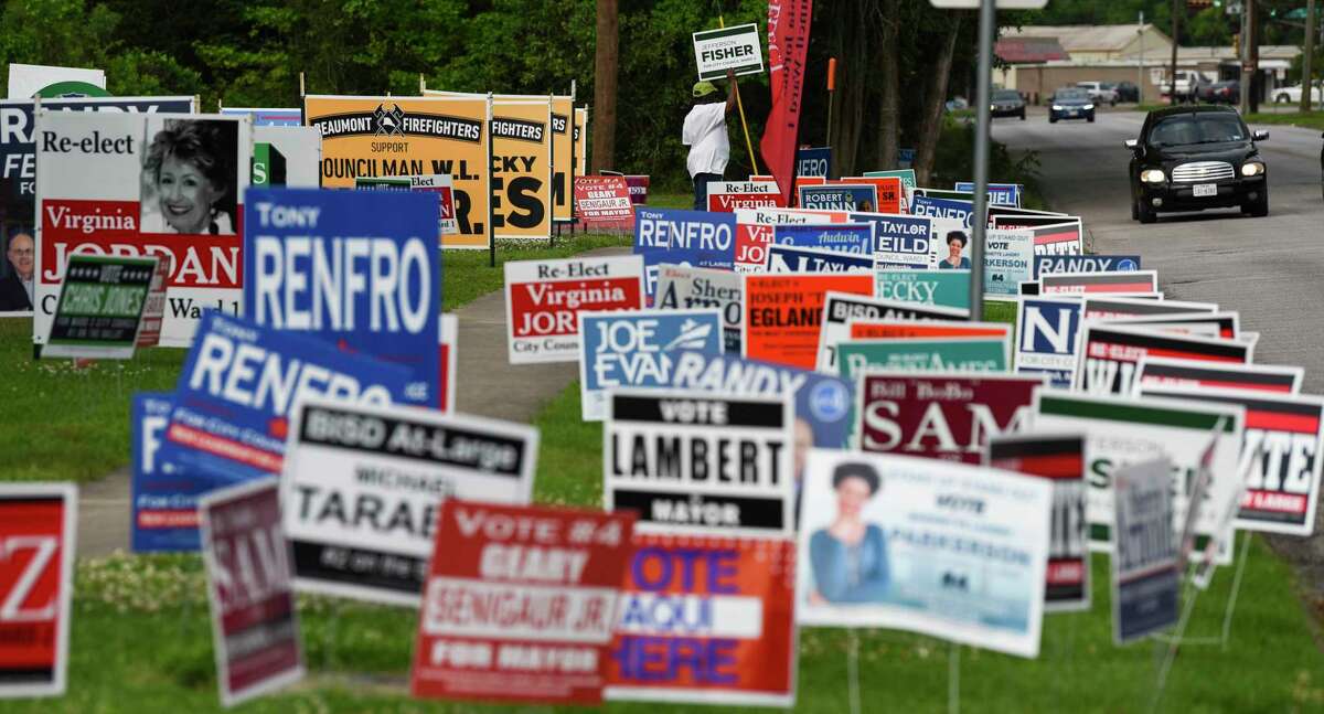 Signs line the road outside of Judge John Paul Davis Community Center Tuesday as people vote early in the area's elections. Photo taken on Tuesday, 04/3019. Ryan Welch/The Enterprise
