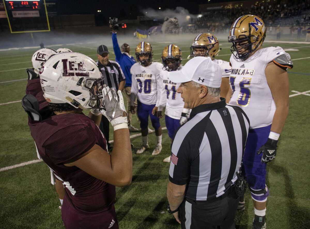 Lee and Midland High meet at the 50 yard line to flip a coin Friday, Nov. 1, 2019 at Grande Communications Field.