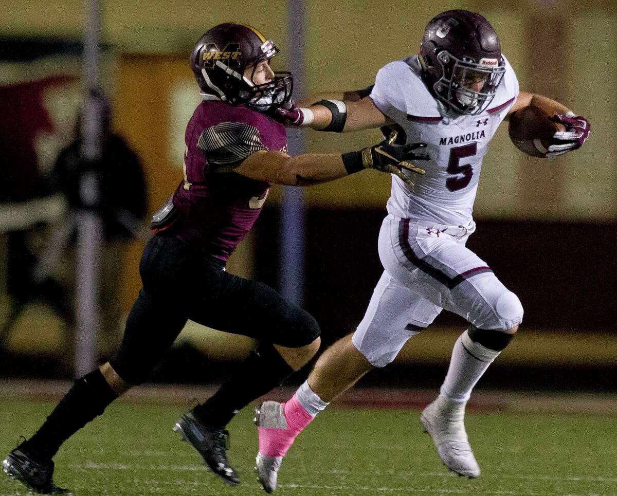 Magnolia running back Mitch Hall (5) stiff-arms Magnolia West linebacker Petton Dyess (36) during the third quarter of a District 8-5A high school football game at Magnolia West High School, Friday, Nov. 1, 2019, in Magnolia.