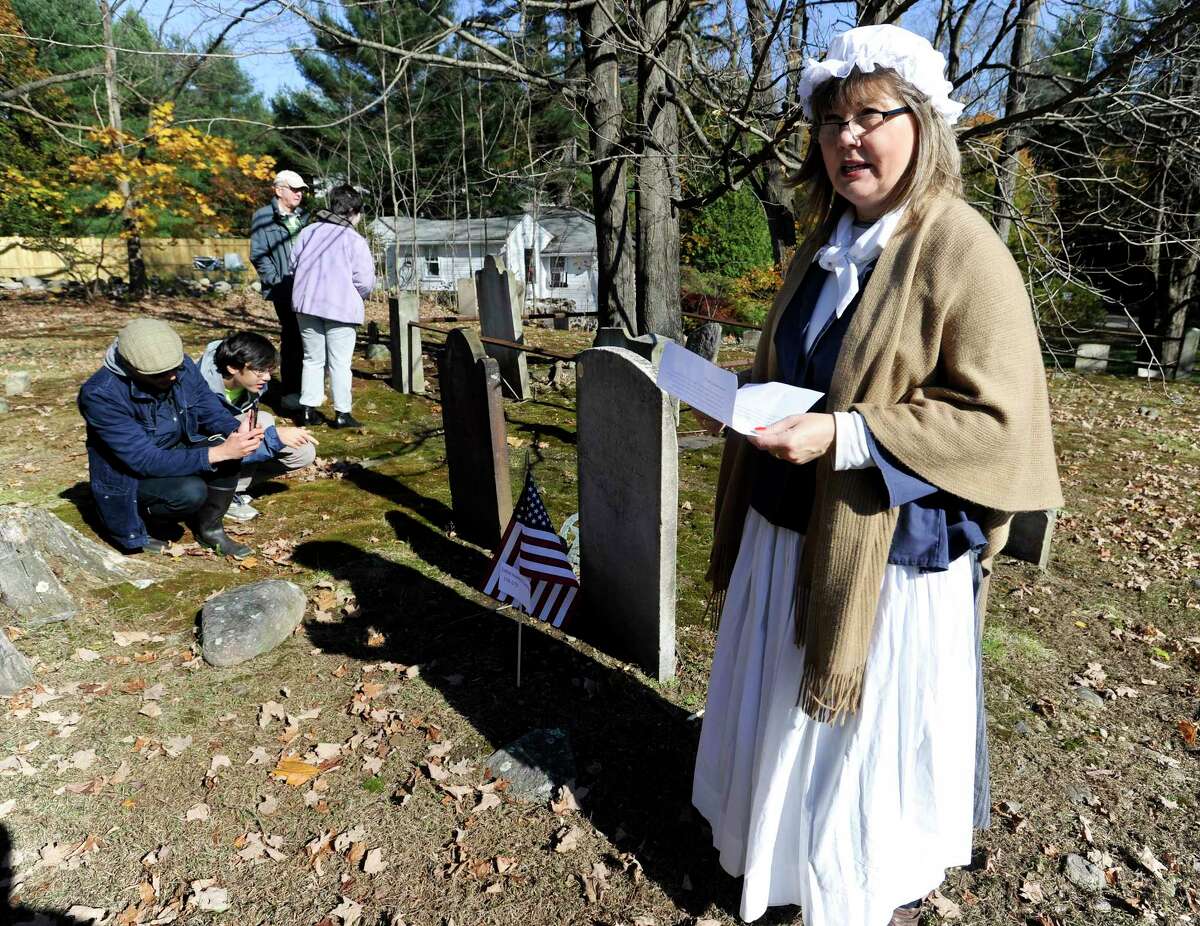 A group of participants gather to listen to Laurie Mapes of Norwalk portrayal of Sarah Betts (1753-1772), who was married to Ezekiel Hawley, as she described her life during the Spirits of the Past cemetery walk and re-enactment at Sharp Hill Cemetery in Wilton, Conn. on Nov. 2, 2019. The event attended by three dozen area residents and sponsored by the Wilton Historical Society and Wilton Congregational Church, Sharp Hill is the oldest surviving cemetery in Wilton, dating back to 1738 when John Marvin gave a small parcel of land to the Congregational Society of Wilton as a site for a meeting house.