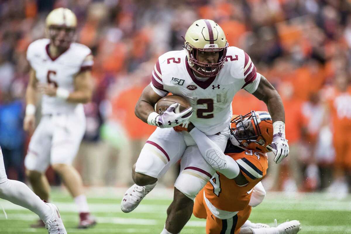 SYRACUSE, NY - NOVEMBER 02: AJ Dillon #2 of the Boston College Eagles drags Eric Coley #34 of the Syracuse Orange as Coley makes the tackle during the second quarter at the Carrier Dome on November 2, 2019 in Syracuse, New York. (Photo by Brett Carlsen/Getty Images)