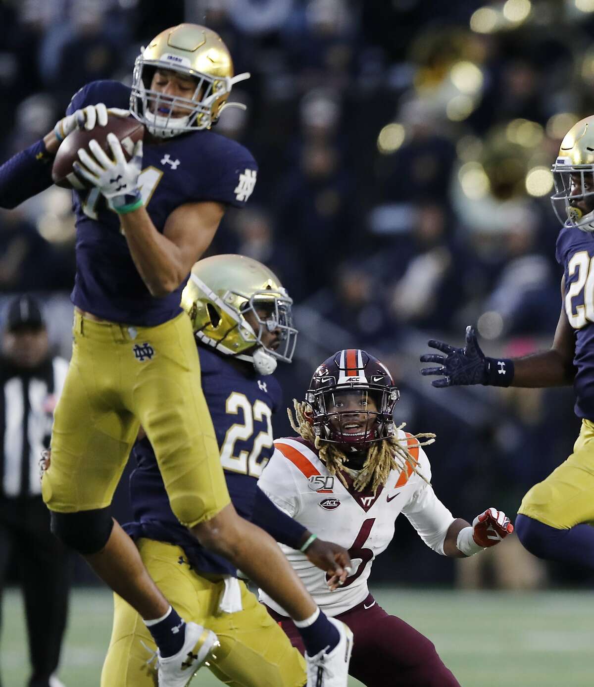 Notre Dame defensive back Kyle Hamilton (14) intercepts a pass intended for Virginia Tech wide receiver Hezekiah Grimsley (6) during the second half of an NCAA college football game, Saturday, Nov. 2, 2019, in South Bend, Ind. (AP Photo/Carlos Osorio)