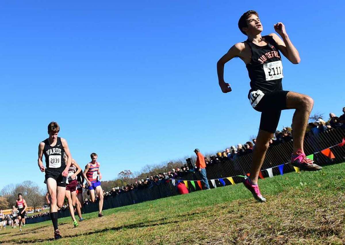 Ridgefield's Chuckie Namiot heads to the finish line at Friday's State Open boys cross country championship.