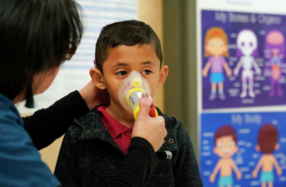 Myrna Sonia Garcia, the nurse at Parker Elementary School, 10626 Atwell Dr., gives first grader, Josue Flores, 6, his inhaler treatment for asthma in her office before he goes outside to play Friday, Nov. 1, 2019, in Houston. She says, out of the school's 912 students, 66 have medically diagnosed asthma. On days when ground-level ozone is high or unhealthy, Houston Independent School District schools are instructed to limit prolonged exercise for all children.