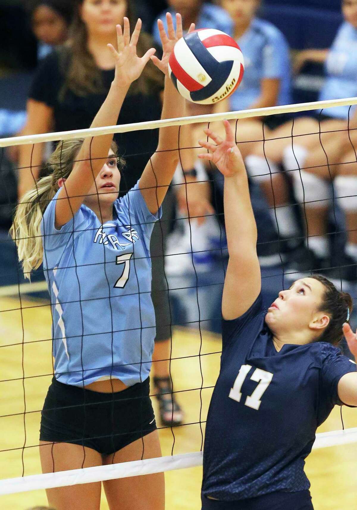 The Hawk's Kiana Fallaha contests a tip shot by the Panther's Ava Himstreet as Harlan plays O'Connor at Taylor Field House on August 120, 2019.