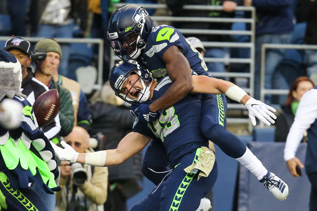 Seattle Seahawks wide receiver David Moore (83) jumps on Seattle Seahawks tight end Jacob Hollister (48) after Hollister scored the game winning touchdownb during overtime in Seattle's game against Tampa Bay, Sunday, Nov. 3, 2019 at CenturyLink Field. The Seahawks won 40-34 in overtime