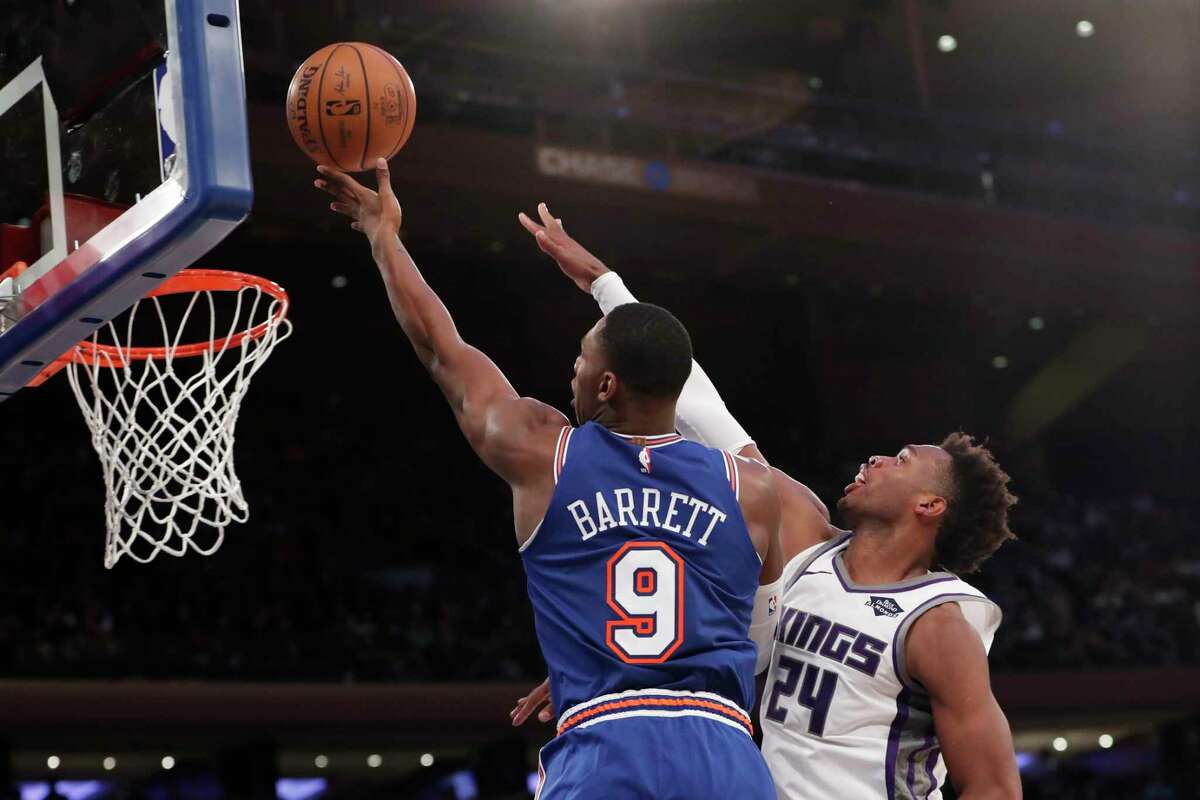 Sacramento Kings guard Buddy Hield (24) defends against New York Knicks guard RJ Barrett (9) during the second half of an NBA basketball game in New York, Sunday, Nov. 3, 2019. (AP Photo/Kathy Willens)