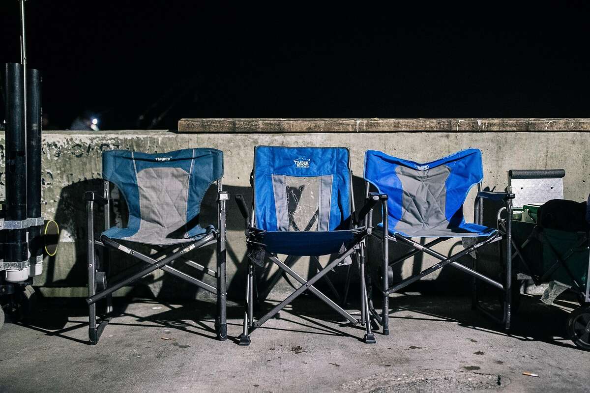 Camping chairs line a section of the Pacifica Municipal Pier during the opening day of California's recreational fishery for Dungeness crab season on Saturday, November 2, 2019 in Pacifica, California.
