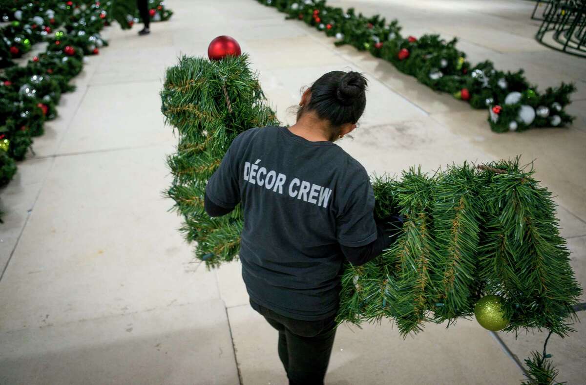 The branches of the Christmas tree at The Galleria are laid out and sorted while the frame of the tree is built late Sunday, Nov. 3, 2019. There are more than 770 branches, with ornaments and LED lights.