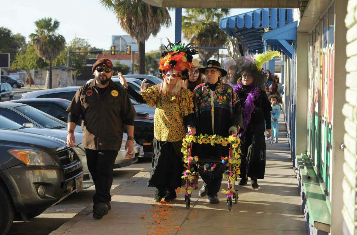 Ramon Vasquez y Sanchez and Maria Chavez are led by a Brown Beret during the Día De Los Muertos on the Old Spanish Trail along Fredericksburg Road. The procession was part of the first big event since the area was named a cultural district by the Texas Commission on the Arts.