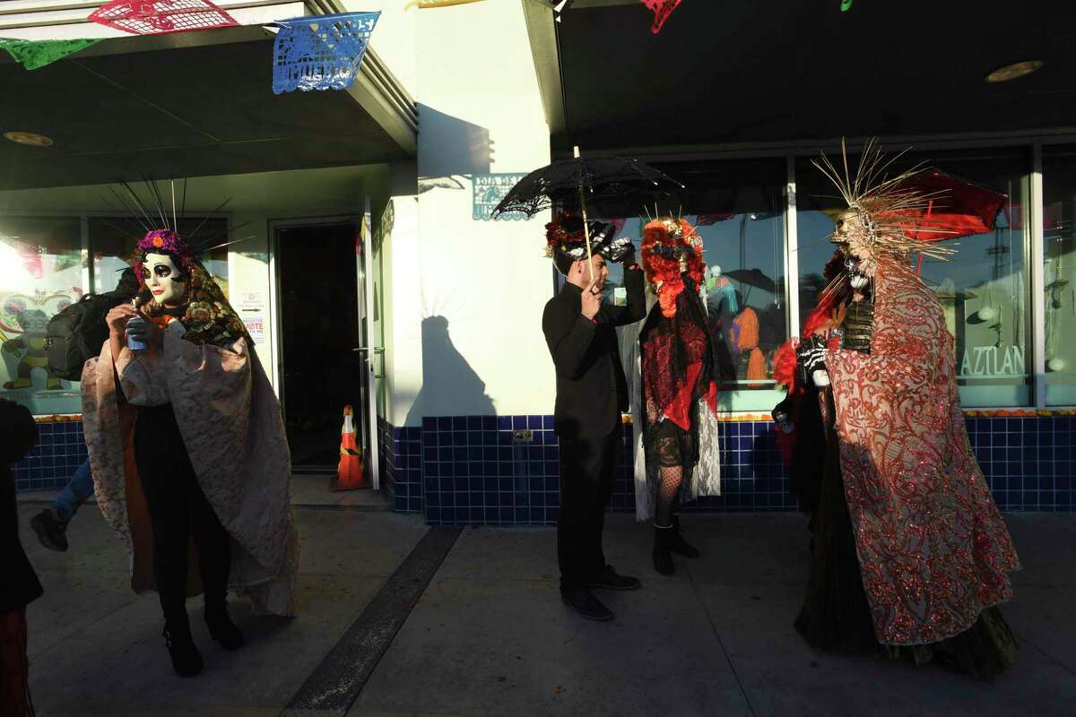 People gather at Centro Cultural Altzan during the Día De Los Muertos celebration. The celebration, a longstanding tradition at the arts organization, was expanded this year to encompass the Old Spanis Trail Cultural Corridor.