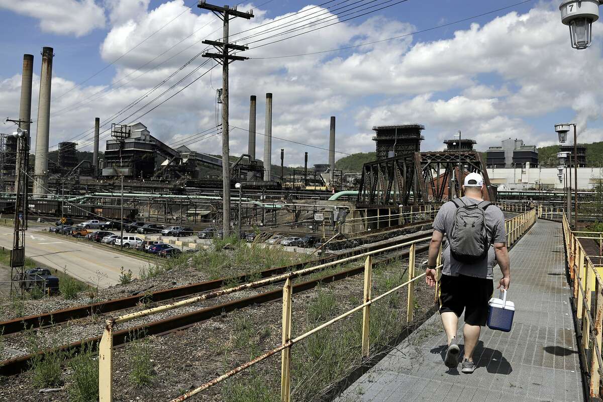 FILE - In this May 2, 2019, file photo a worker arrives for his shift at the U.S. Steel Clairton Coke Works in Clairton, Pa. (AP Photo/Gene J. Puskar, File)