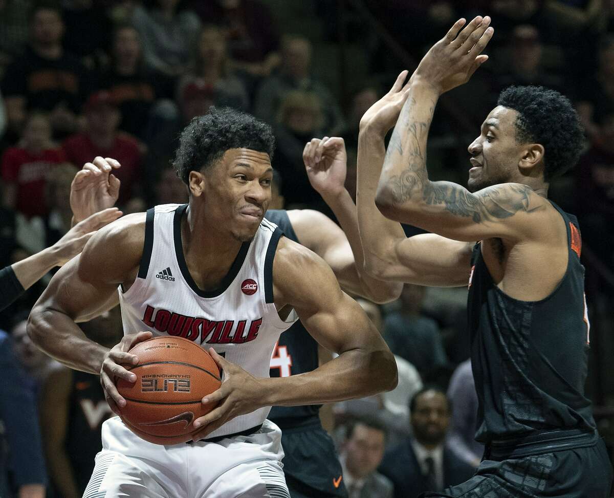In this Feb. 4, 2019, file photo, Louisville forward Dwayne Sutton, left, looks to pass against Virginia Tech guard Nickeil Alexander-Walker (4) during the first half of an NCAA college basketball game, in Blacksburg, Va. Louisville is back in the national championship conversation after the basketball program was knocked on its heels amid the fallout of embarrassing scandals, including the school’s missteps that were discovered in a federal investigation into college basketball and escorts performing in players’ dorm.