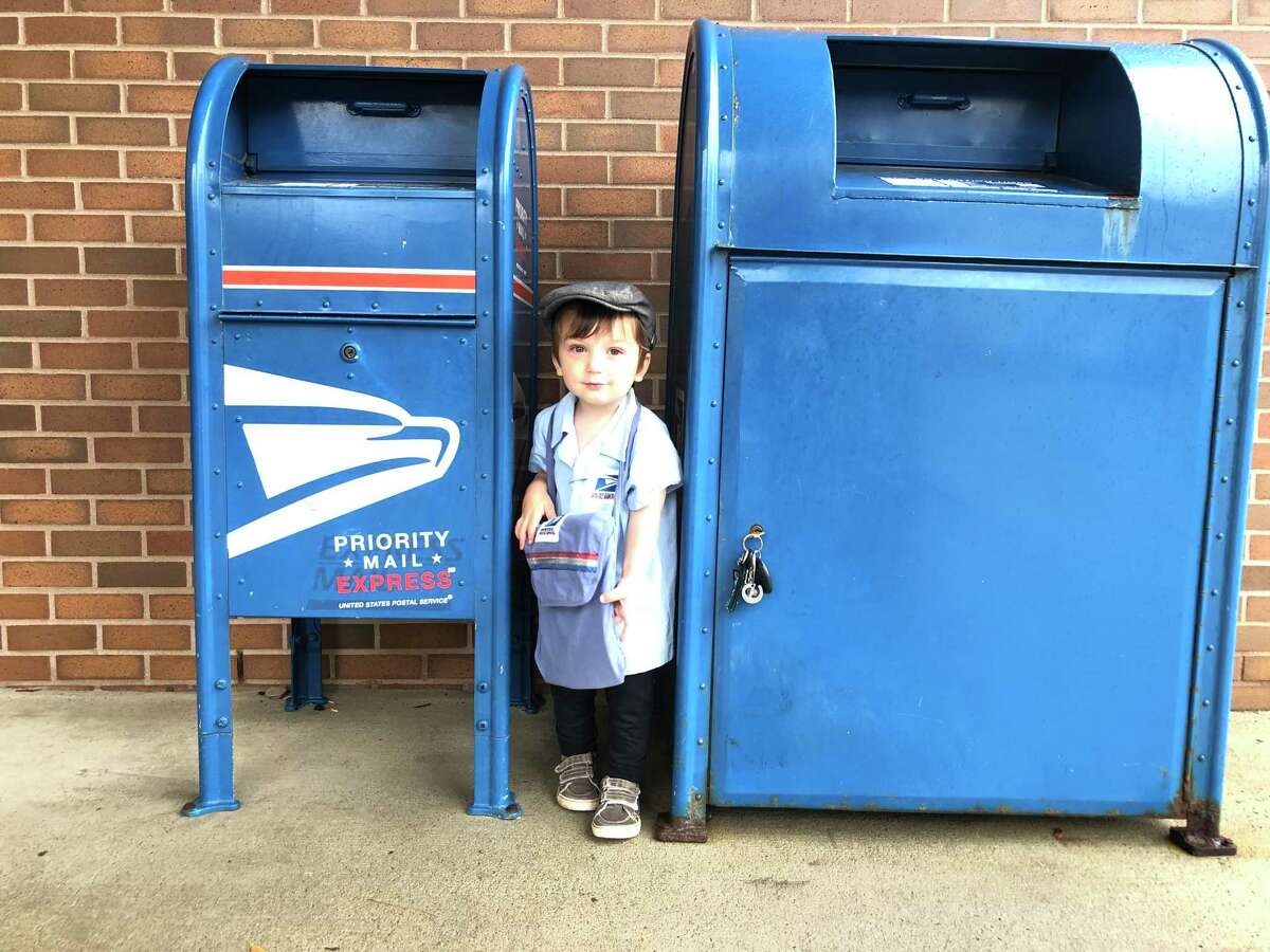 Owen, 2, dressed up as a mail carrier at the Ridgefield Post Office on Halloween.