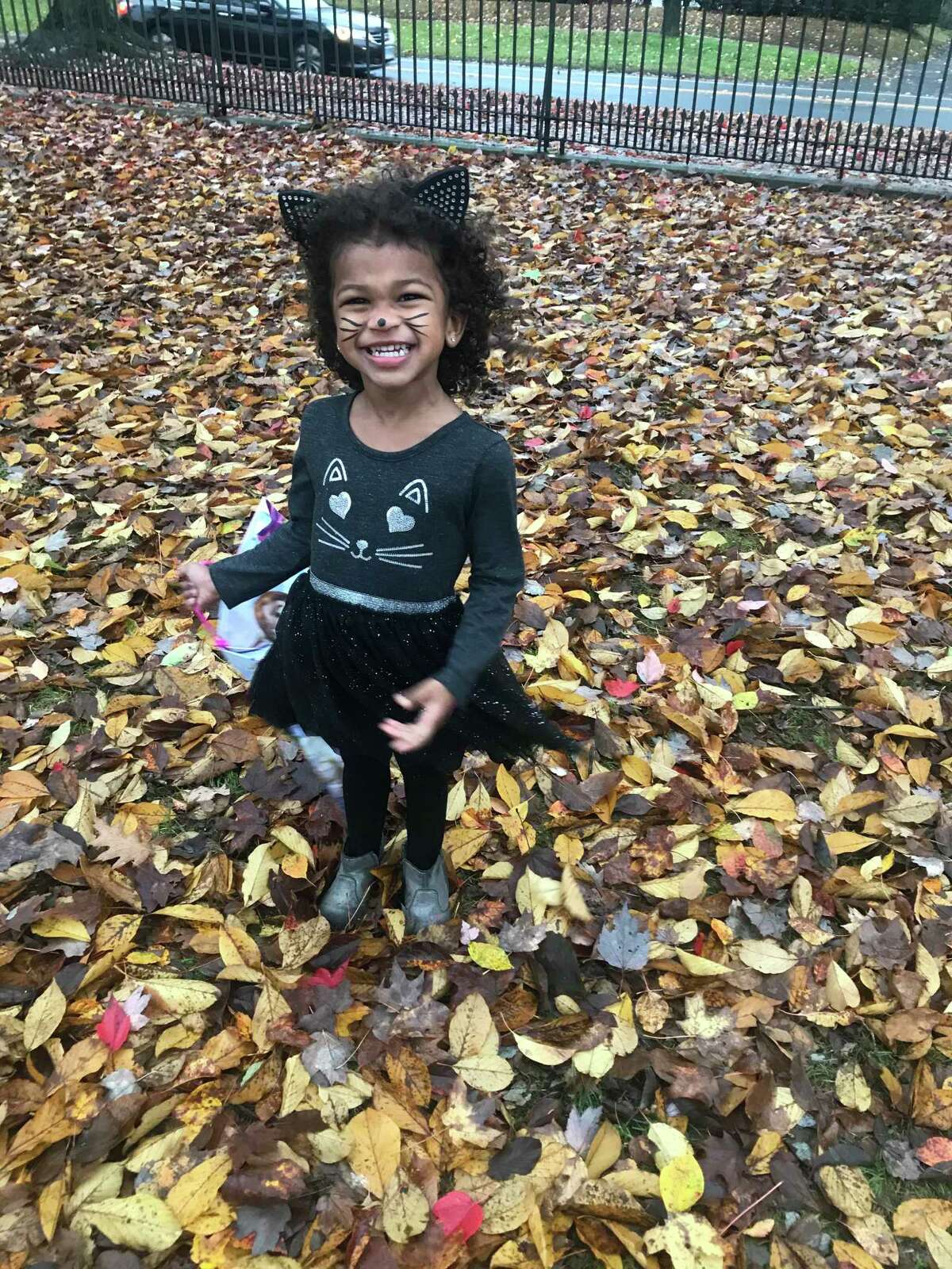 Sophie dresses as a kitty cat in front of Lounsbury House on Halloween night, Oct. 31, 2019.