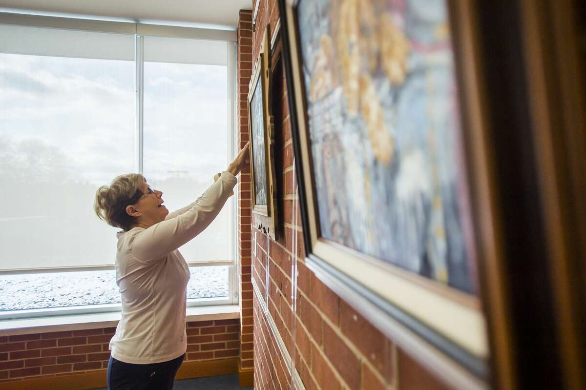 Members of the Paint and Palette group set up their art show Friday, Nov. 1, 2019 on the mezzanine of the Grace A. Dow Memorial Library. The show will run through the month of November, and is dedicated to Dorothy Lynch, a long-time Paint and Palette member who died in February of 2018. (Katy Kildee/kkildee@mdn.net)