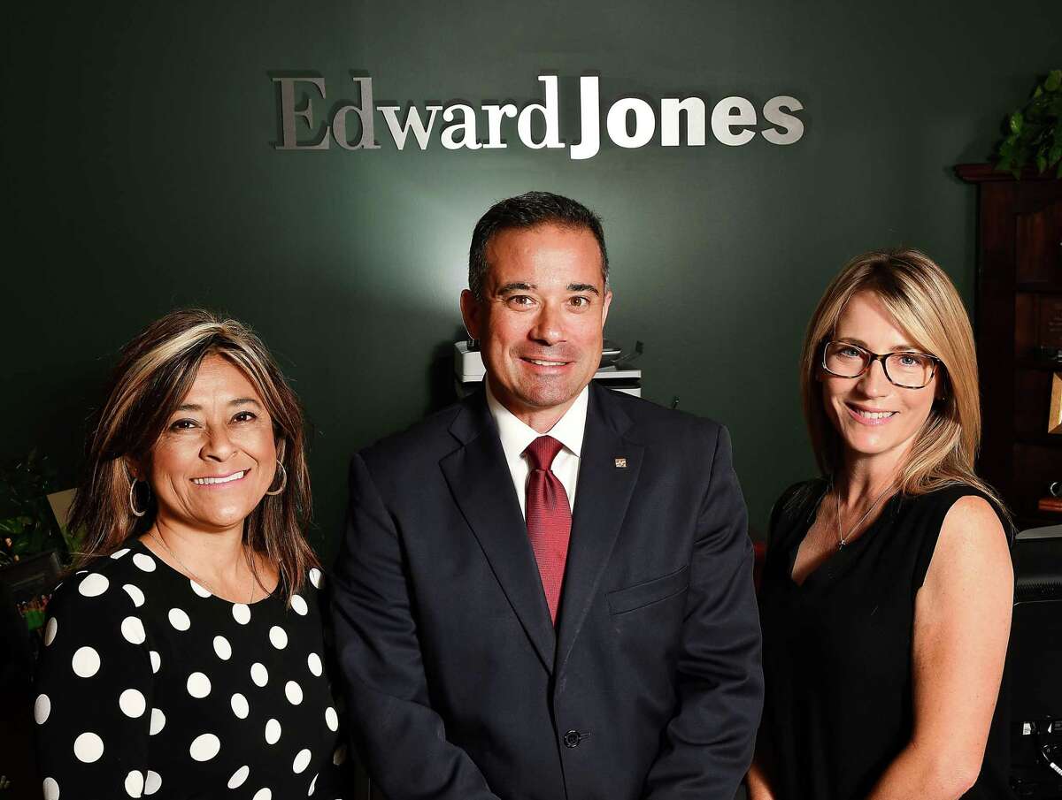Financial adviser Paul Dimiceli II with Kerrie Bass, left, and Melanie Dimiceli at one of Edward Jones’ many area offices.