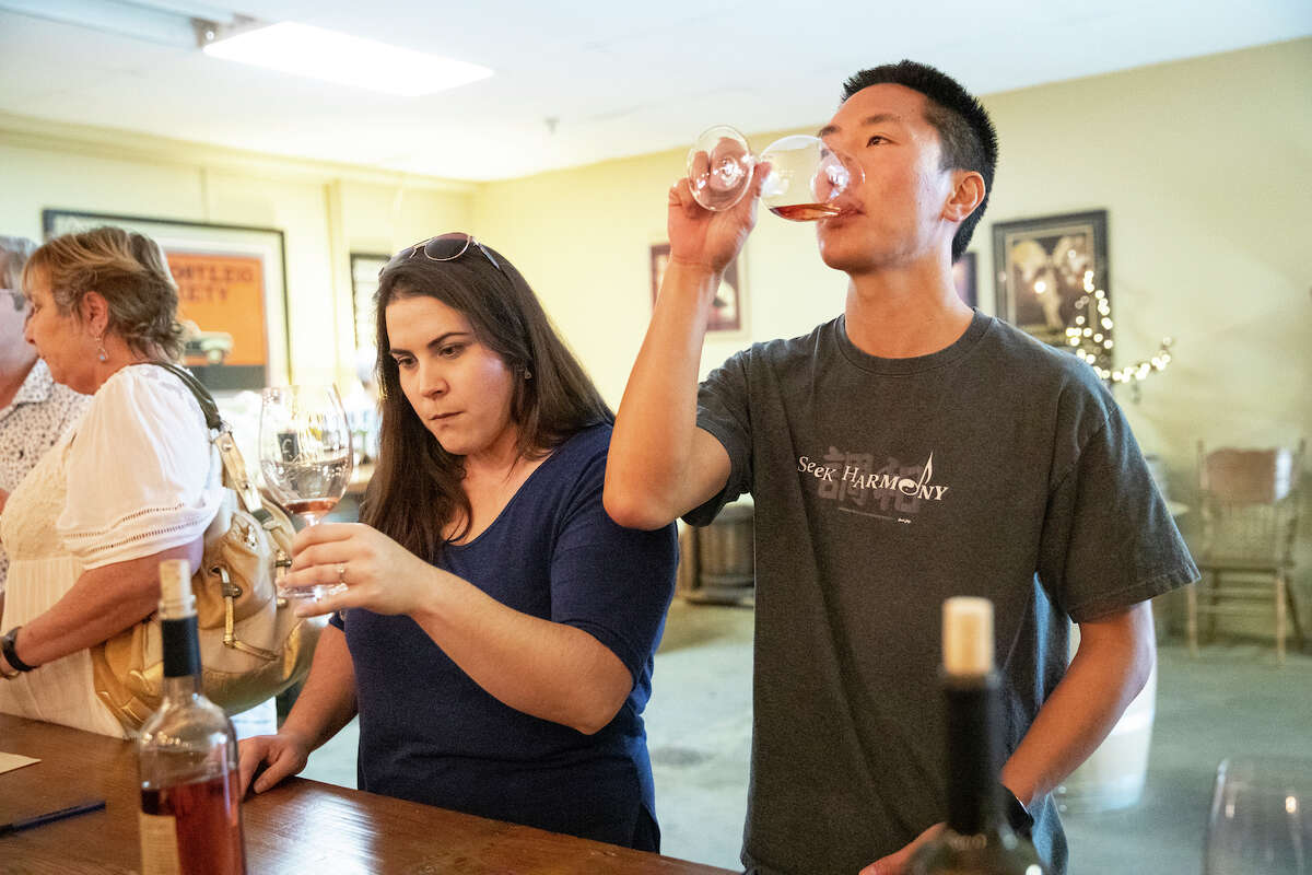 Alivia Logan (left) and Jeff Kumagai taste wine at St. Amant Winery in Lodi, Calif., on Friday, October 11, 2019.