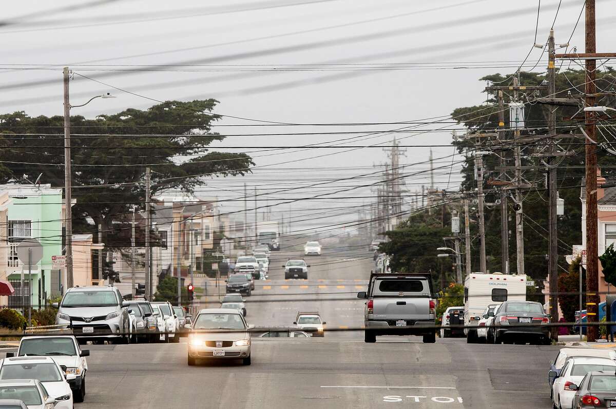 PG&E power lines cross over a view of homes and Ocean Beach seen from Rivera Street in the Sunset District of San Francisco, Calif. Friday, July 26, 2019.