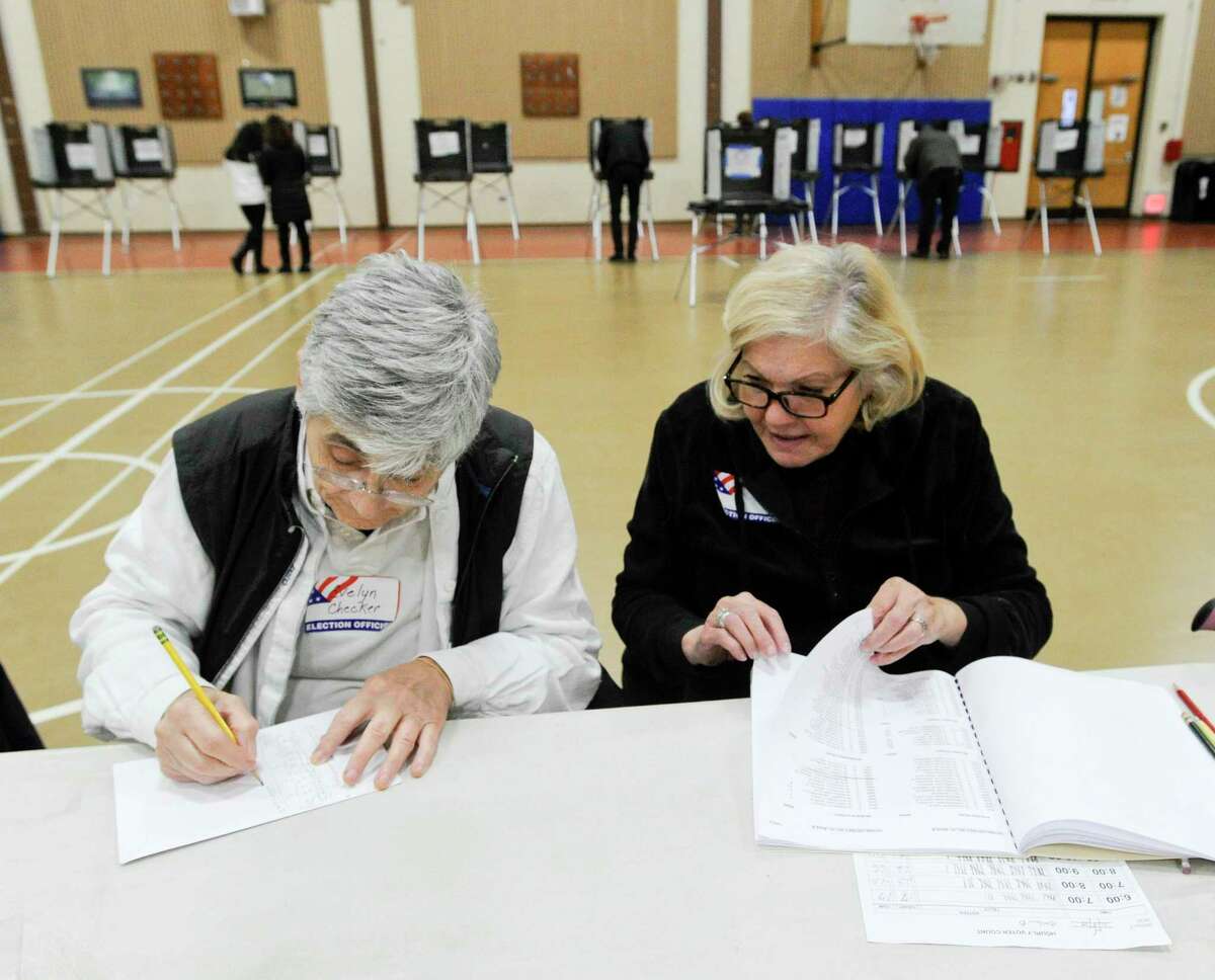 From left, Evelyn Avoglia and Lucy Esposito tally up voter turn out at the District 14 polling site at Stillmeadow Elementary School on Nov. 5, 2019 in Stamford, Connecticut. Election workers are task with keeping hourly records of voter turnout while the polls are open.