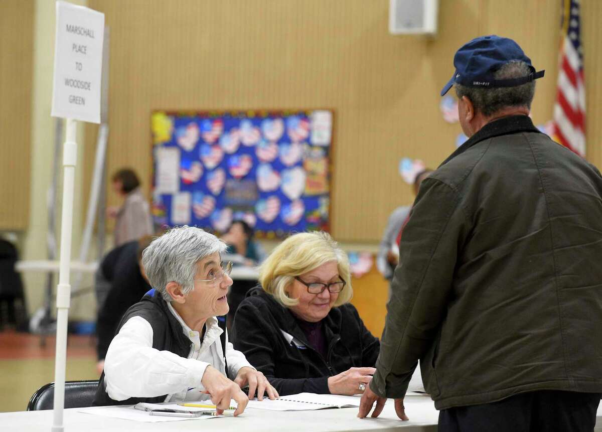 From left, Evelyn Avoglia and Lucy Esposito check in voters at the District 14 polling site at Stillmeadow Elementary School on Nov. 5, 2019 in Stamford, Connecticut.