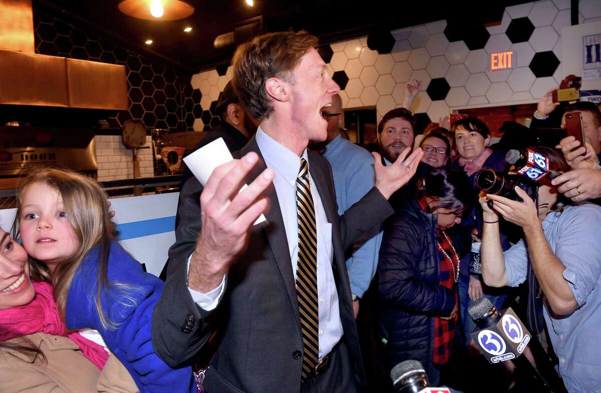 Justin Elicker (center) celebrates his victory in the mayoral race against incumbent Mayor Toni Harp with his wife, Natalie (left) and daughter, Molly, 4, at Next Door restaurant in New Haven on November 5, 2019.