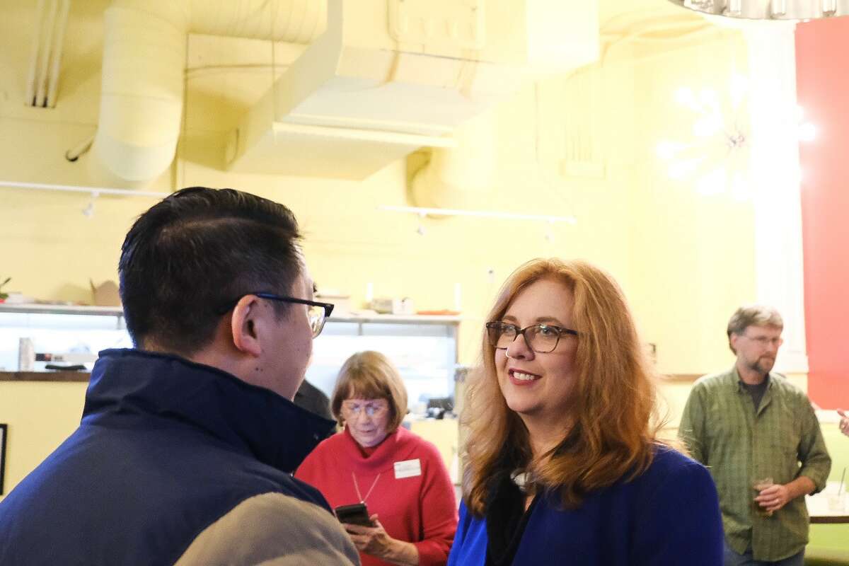 Seattle City Council District 1 incumbent Lisa Herbold speaks to Sen. Joe Nguyen.
