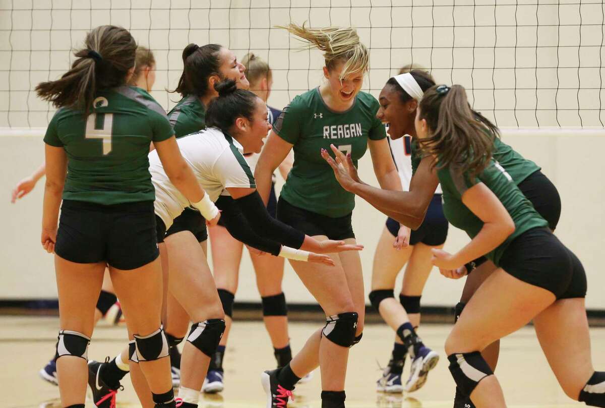 The Reagan volleyball team celebrates after taking a contentious first game against Brandeis in Class 6A bidistrict high school volleyball playoff at Littleton Gym on Tuesday, Nov. 5, 2019. (Kin Man Hui/San Antonio Express-News)