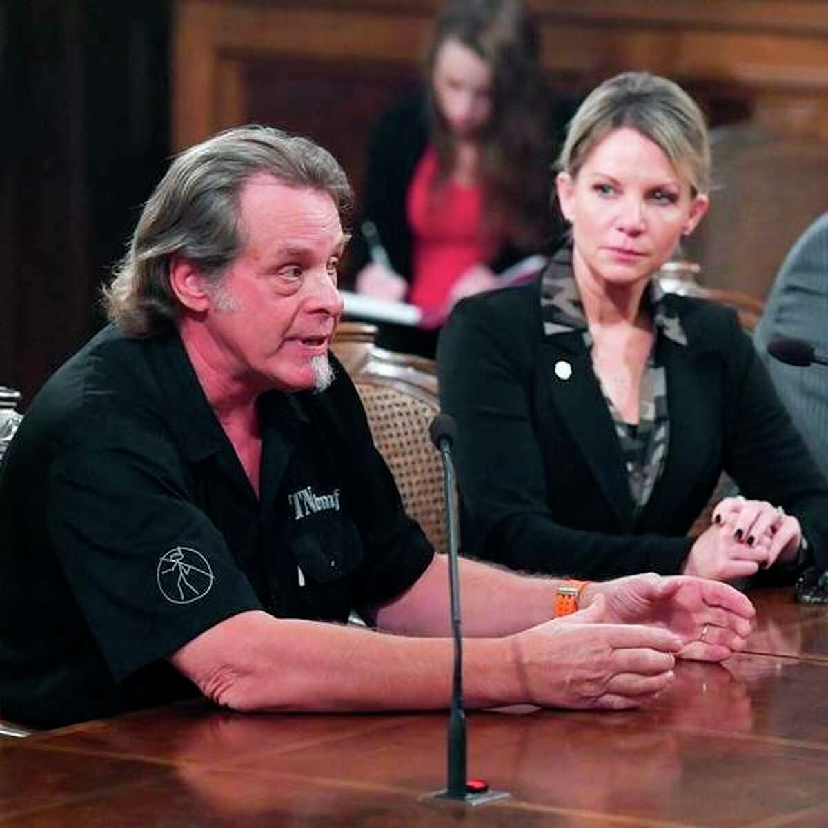 State Rep. Michele Hoitenga, R-Manton, and rocker Ted Nugent, pictured at left, testify Sept. 17 in support of her plan to end the ban on baiting deer in Michigan. (Courtesy photo)