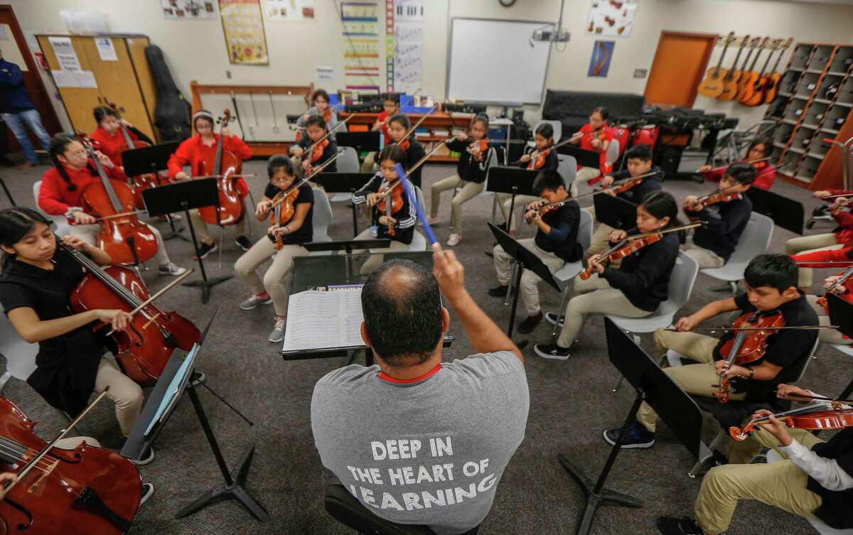 Pilgrim Academy orchestra conductor Mario Garcia leads his students at the Houston ISD campus on Wednesday, Oct. 30, 2019. The west side school boasts many enrichment and extracurricular activities, from music to chess to kickball, that campus leaders say contributes to academic success.