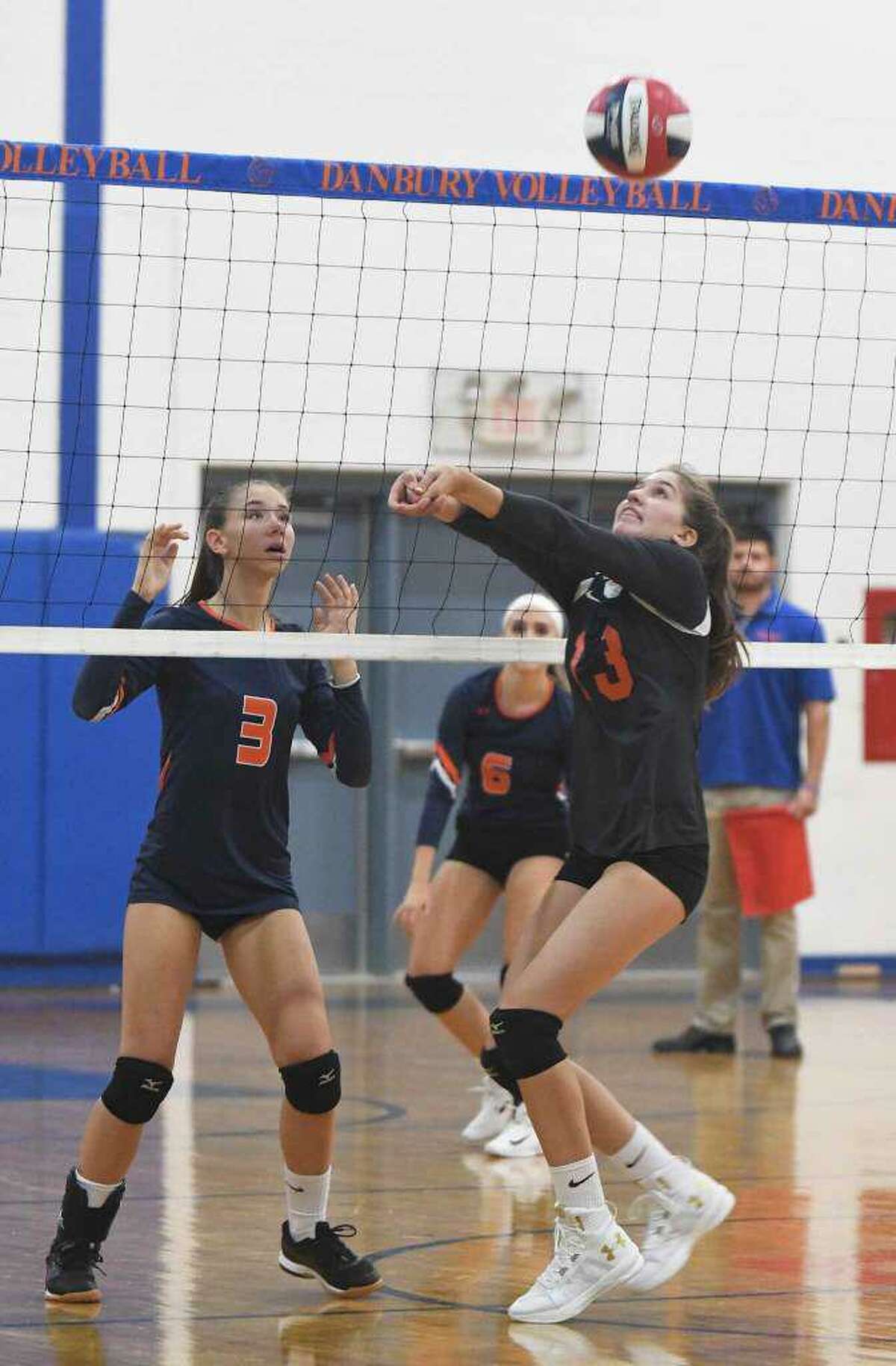 Isabel Voellmicke (#13) and the Ridgefield girls volleyball team qualified for the Class LL state tournament by beating Danbury, 3-1, in the final regular-season match last Friday. Voellmicke had 11 assists and 11 service points (six aces) for the Tigers, who are 8-10 this year. Catherine Maguire added 14 kills and four blocks, while Mathilde Verbitsky contributed 13 kills and Julia Kocsis had six kills, 10 digs, and eight service points.