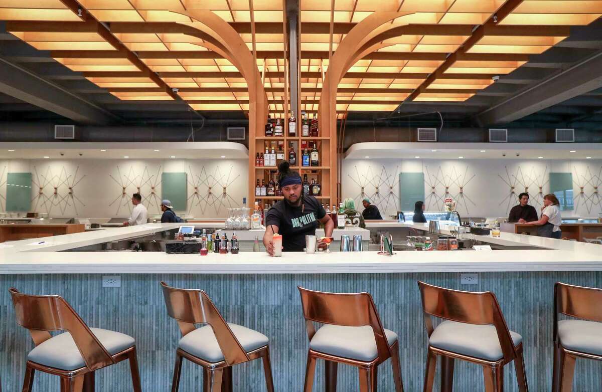 Amaud Butler serves a La Alondra cocktail at Politan Row, the new Rice Village food hall at 2445 Times Blvd. that features a bar and eight dining concepts under one roof.