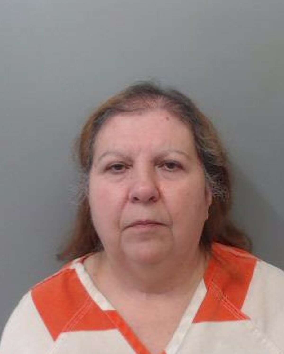 Gloria de Leon Diaz, 61, was served with an arrest warrant on Monday and charged with theft of property.