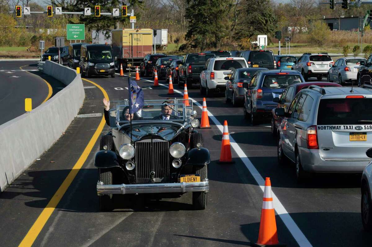 Governor Andrew Cuomo drives FDR's Packard with Marie Therese Dominguez, Commissioner of DOT, Albany County Executive Dan McCoy, and Albany Mayor Kathy Sheehan, over the finished flyover for the new exit 3 off of Interstate 87, on Wednesday, Nov. 6, 2019, in Colonie. The new ramp is part of improvements at and around Albany International Airport.(Paul Buckowski/Times Union)