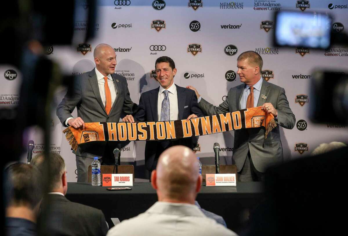 Matt Jordan, from left, senior vice president and general manager of the Houston Dynamo, Tab Ramos, Houston Dynamo head coach, and John Walker, president of business operations, pose for photos during a press conference at BBVA Stadium on Wednesday, Nov. 6, 2019, in Houston. The team formally introduced Ramos, who was previously the U.S. men's U-20 head coach.