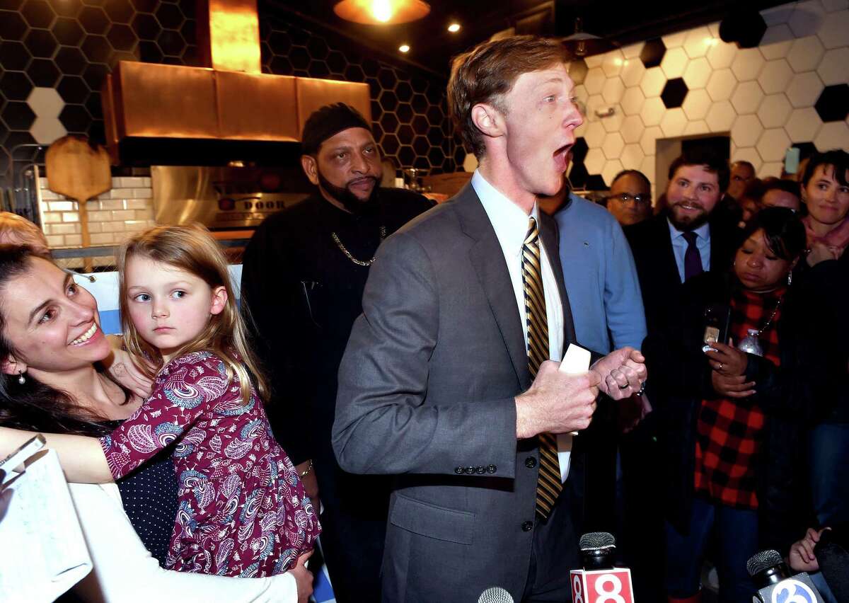 Justin Elicker (center) celebrates his victory in the mayoral race against incumbent Mayor Toni Harp with his wife, Natalie (left) and daughter, Molly, 4, at Next Door restaurant in New Haven on November 5, 2019.