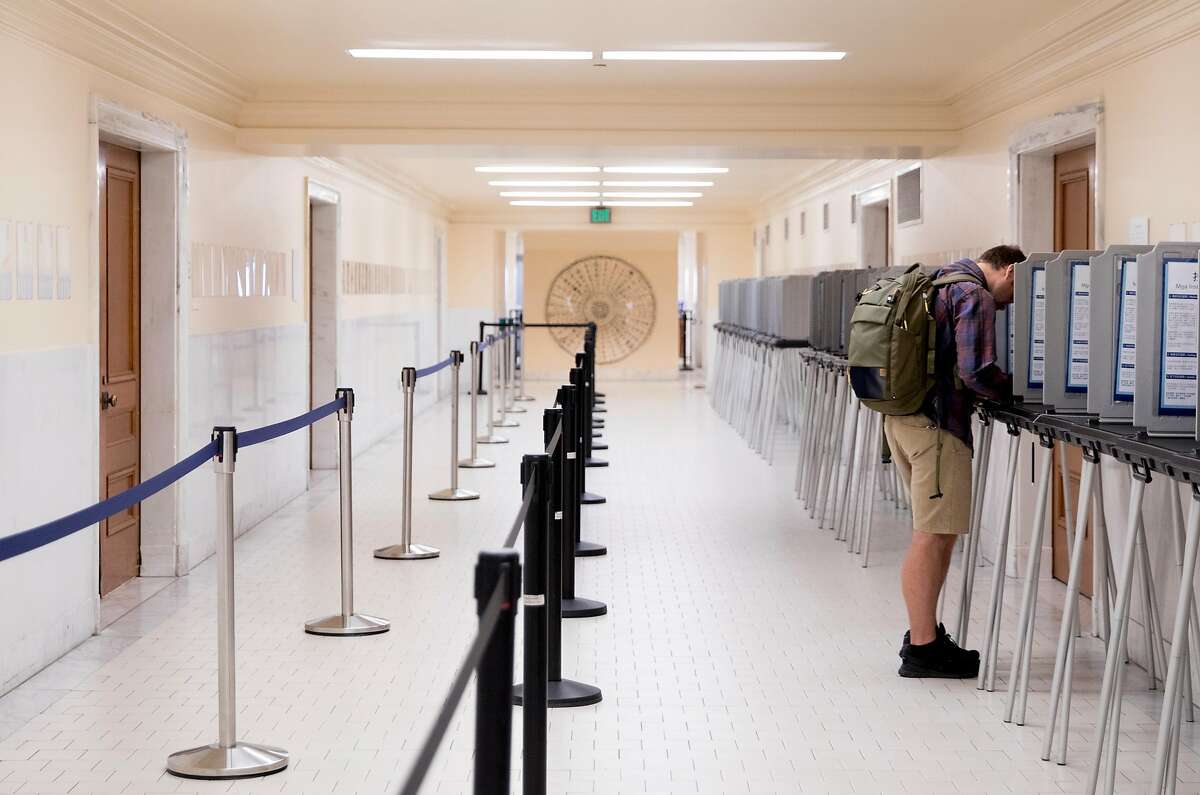 A man (no name given) stands alone in a row of poll booths as he casts his vote at San Francisco City Hall in San Francisco, Calif. Tuesday, Nov. 5, 2019.