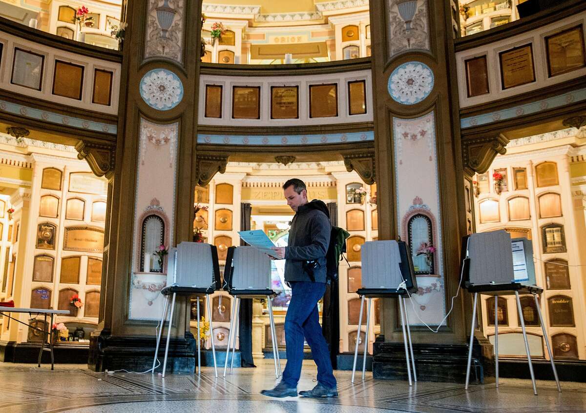 Adam Degregorio turns in his ballot after voting at the polls located at the San Francisco Columbarium in San Francisco, Calif. Tuesday, Nov. 5, 2019.