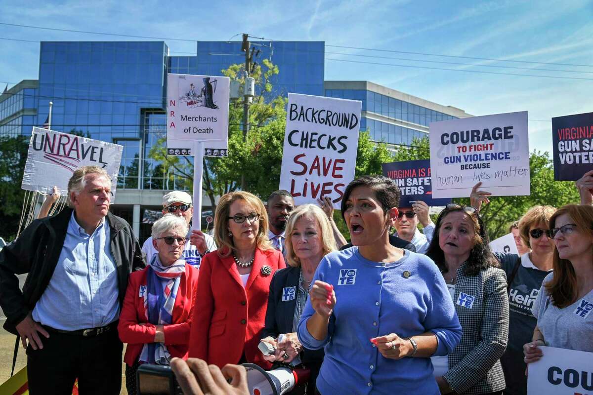 Terry McAuliffe attends a September gun-control rally outside the headquarters of the National Rifle Association in Fairfax County with former congresswoman Gabrielle Giffords, D-Ariz., center, and Del. Hala Ayala, D-Prince William, second from right, who is running for reelection. MUST CREDIT: The Washington Post by Jahi Chikwendiu