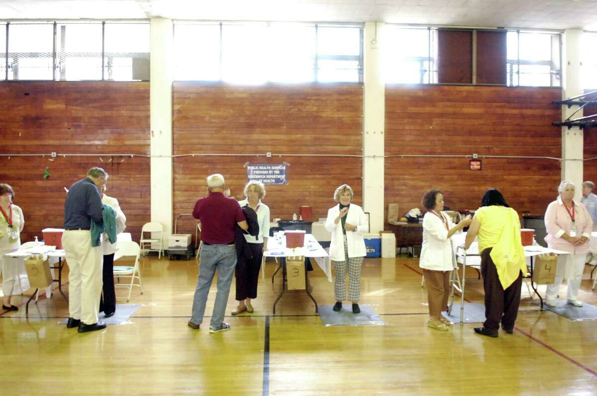 Greenwich Department of Health volunteers administer vaccines in 2009.