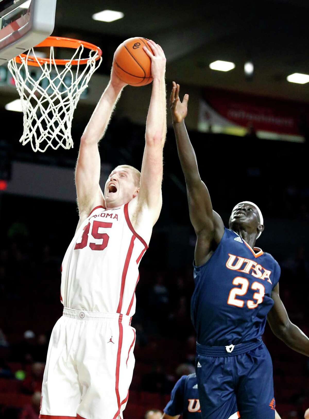Oklahoma's Brady Manek (35) goes up for a basketa as UTSA's Atem Bior (23) defends during the college basketball game between the University of Oklahoma and the UTSA Roadrunners at the Lloyd Noble Center in Norman, Okla., Tuesday, Nov. 5, 2019. [Sarah Phipps/The Oklahoman]