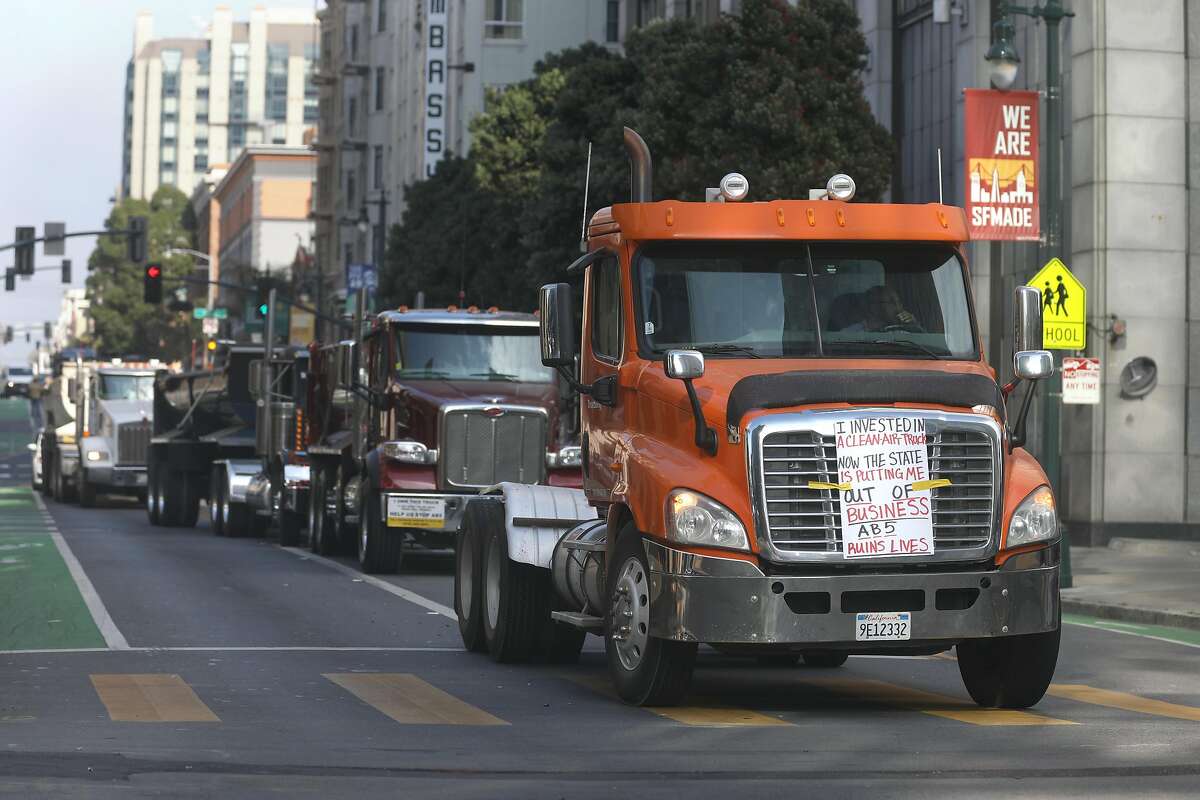 Trucks on Polk St. display signs in protest of AB5 on Wednesday, Nov. 6, 2019, in San Francisco, Calif.