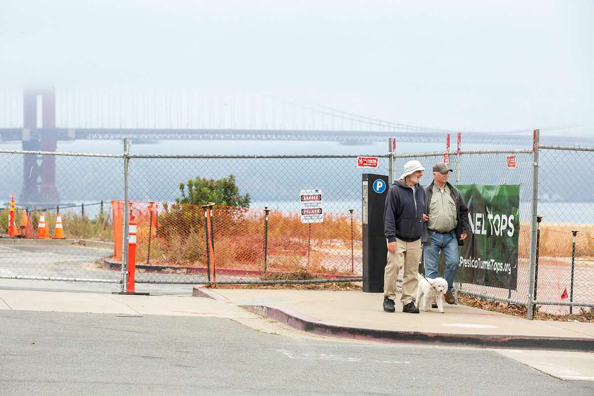 John Fraser (left), his dog Lula, and Rick Black look at the Presidio Tunnel Tops development for which planning started in 2014. The project has a budget that has escalated over the years to $118 million.