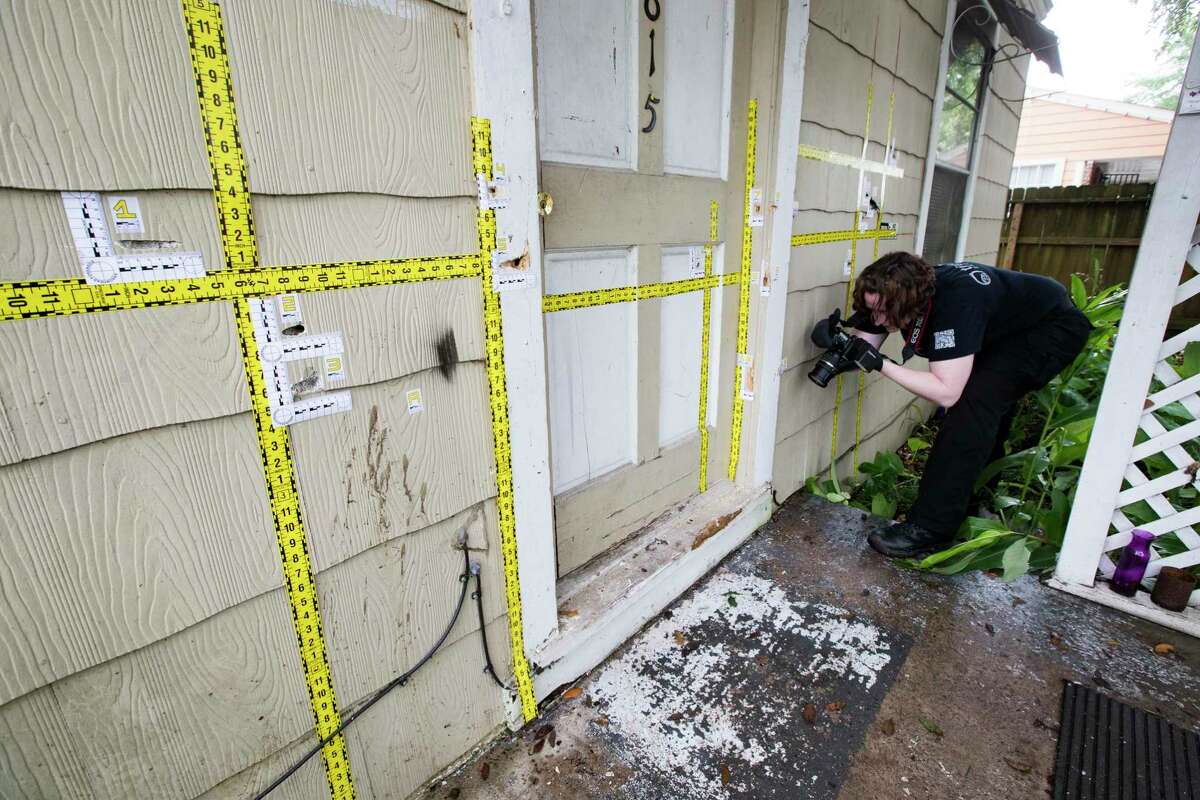 An out of state forensic photographer brought by the family of the killed homeowners at a botched drug raid work the bullet holes still at the home on 7815 Harding on Friday, May 10, 2019, in Houston. The home was the scene of a botched drug raid that took place on Jan. 28, 2019 and left the two homeowners dead and five police officers injured.