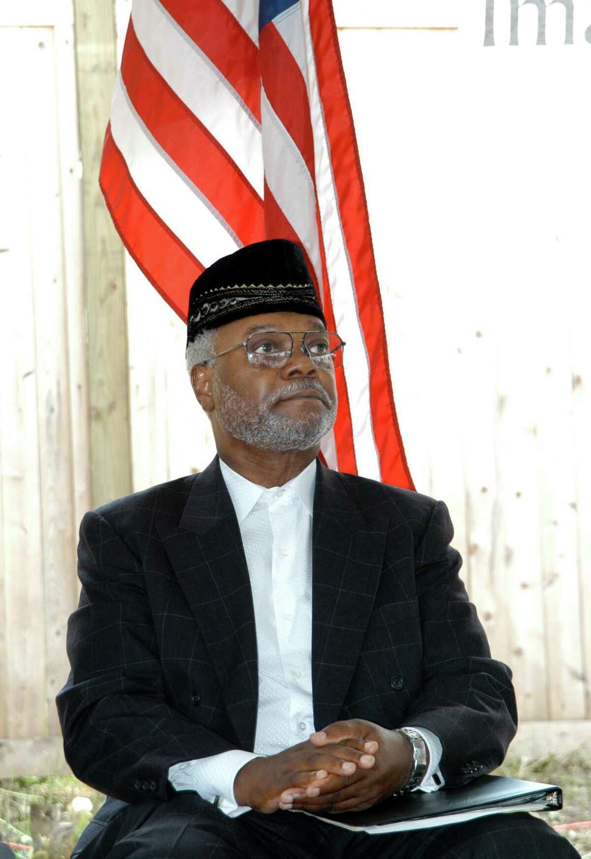 Imam Abdul-Majid Karim Hasan listens to speakers honoring him at a special ceremony at his Hamden mosque in 2004.